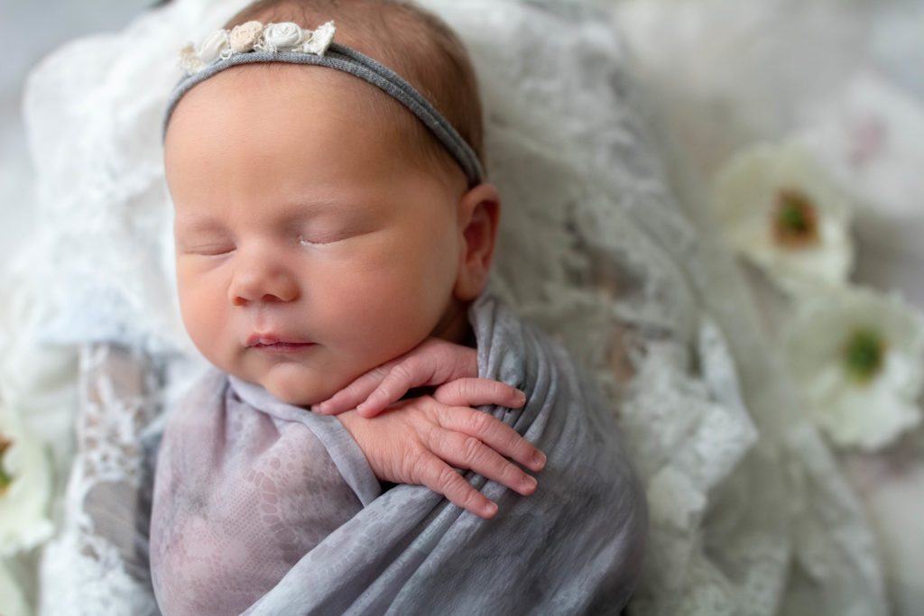 chattanooga newborn photographer baby in lace and grey with flowers studio session